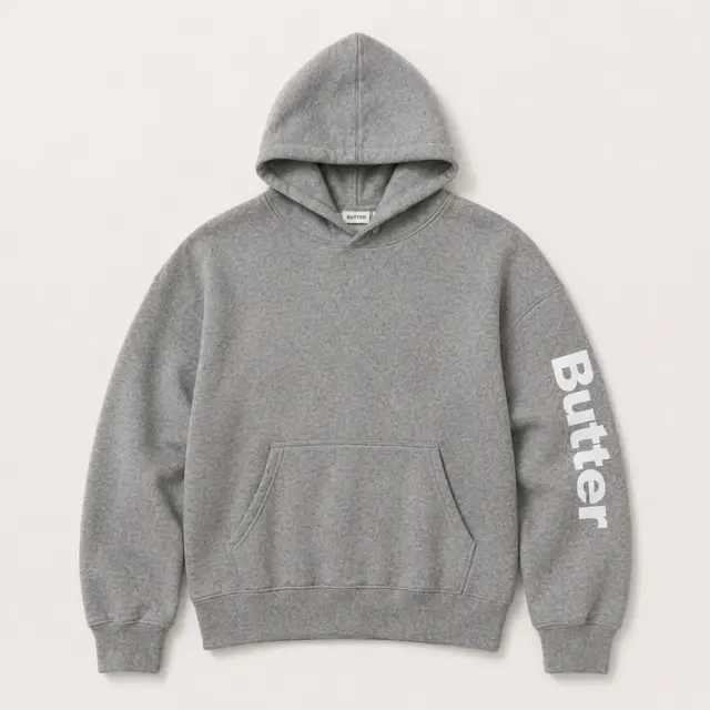 Light grey heather pullover hoodie flat lay with rhinestone 'BUTTER' logo on the sleeve.