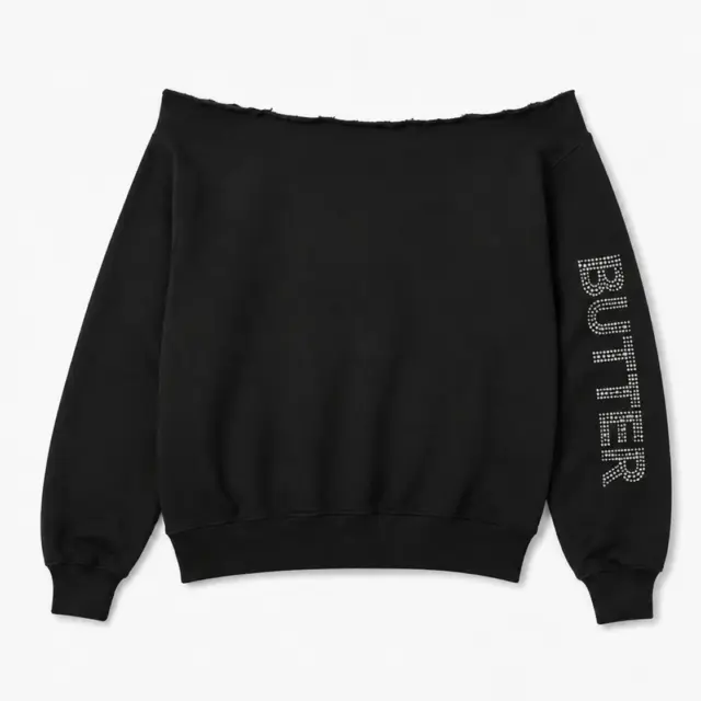 Black off-the-shoulder sweatshirt with a rhinestone 'BUTTER' logo on the left sleeve.