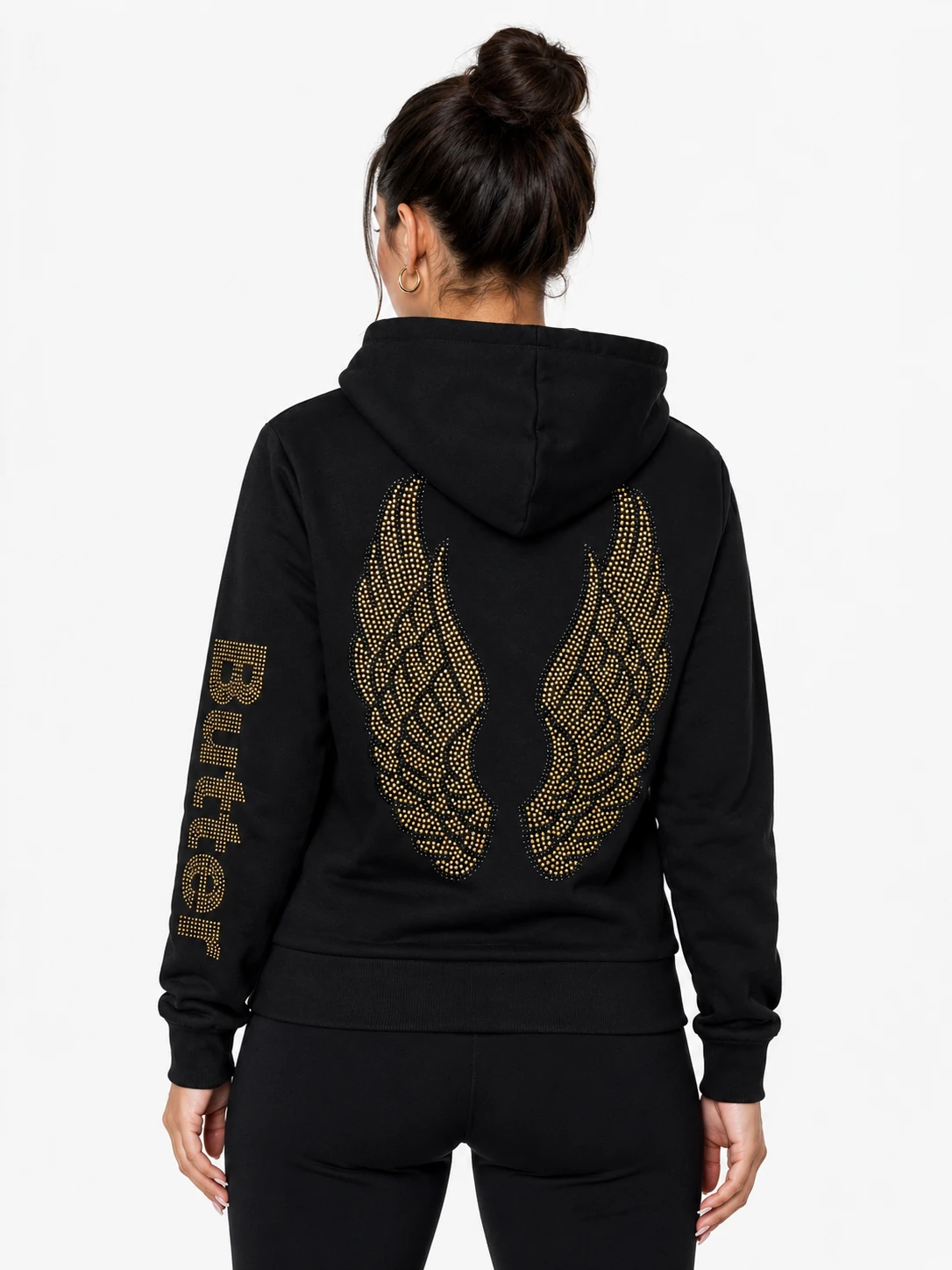 Black zip-up hoodie with gold wings graphic on the back and gold 'Butter' text on the sleeve, worn by a model, back view.