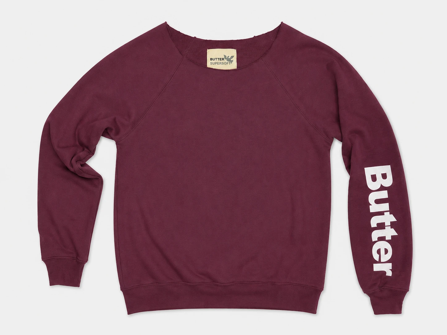 Burgundy off-the-shoulder sweatshirt with a white vertical logo on the left sleeve and raglan sleeve construction.