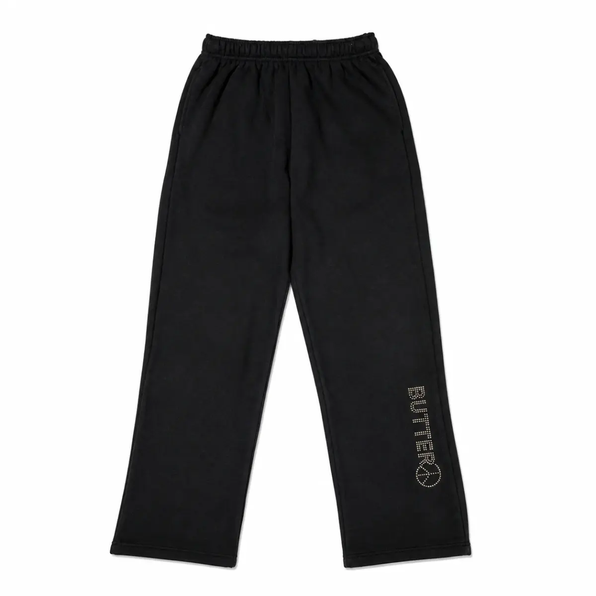 Flat lay of black wide-leg sweatpants featuring a silver 'BUTTER' and peace sign logo on the lower left leg.