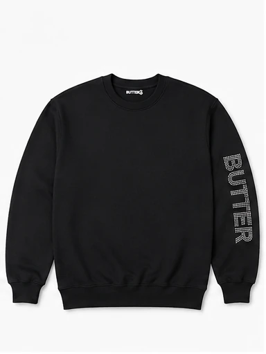 Black crewneck sweatshirt flat lay with rhinestone 'BUTTER' logo on the sleeve.
