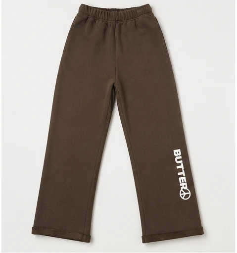 Wide-leg sweatpants in espresso brown with a white 'BUTTER' logo and peace sign on the lower leg.