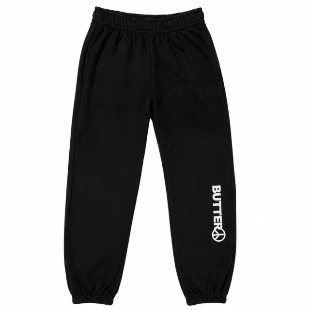 Black sweatpants with a white vertical logo and peace sign graphic on the lower left leg, featuring an elastic waistband and elasticated cuffs.